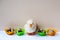 Natural organic quail eggs in colorful silicone molds and cuddly toy duck on light background.