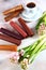 Natural pastille rolled into a cone with a Cup of tea on a light background. Pink hyacinths nearby. Copy of the space.Top view