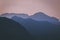 Natural patterns: layers of mountains in a foggy soft light at sunset. Garda Lake, Italy. Artistic, almost abstract