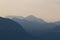 Natural patterns: layers of mountains in a foggy soft light at sunset. Garda Lake, Italy. Artistic, almost abstract