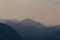 Natural patterns: layers of mountains in a foggy soft light at sunset. Garda Lake, Italy. Artistic, almost abstract