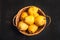 Natural pear fruit with defects in basket on dark wooden background