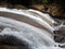 This is a natural photo of a waterfall in a tourist park, Makassar, South Sulawesi