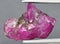 Natural pink ruby rough gem on the background