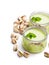 Natural pistachio yogurt in a small glass jar isolated on white