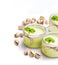 Natural pistachio yogurt in a small glass jar isolated on white