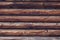 Natural planed wood texture. Rustic round painted log wall horizontal background