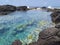 Natural pool with turquoise waters in the Caribbean Sea. Swimming area in tropical paradise. Natural lagoon delimited by rocks