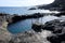 Natural pool on volcanic rocks shore