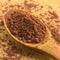 Natural powdered cocoa in wooden spoon, on wooden cutting board