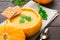 Natural pumpkin with vegetarian pumpkin soup with greens and bread