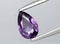 natural purple spinel gem on the background