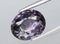 natural purple spinel gem on the background