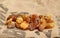 Natural raw amber stones on jute bag background. Multiple amber gemstone in various shapes and colour. Jewelry components.