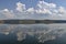 Natural reflection on Vlasina Mountain Lake and beautiful cloudy sky