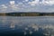 Natural reflection on Vlasina Mountain Lake and beautiful cloudy sky