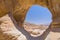 Natural rock arch formation and desert view in Timna National Park, Israel.