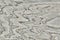 Natural rock of igneous origin with iron. Texture of white stone surface with wavy line. Background gray stone with patches of