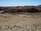 Natural rock mountain texture landscape background of Namib desert unique geography with splitting stone sandy ground, desert tree