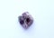 Natural rough purple fluorite crystal on white background