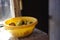 Natural rural apples in a yellow bowl on a sunny rustic windowsill