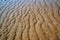 Natural sand patterns in beach at low tide.