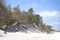 Natural seaside landscape from the Baltic Sea beach with white sand dunes and pine trees growing on them