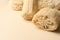 Natural shower loofah sponges on beige background, closeup. Space for text