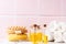 Natural skin care products. Bottles with organic wheat germ oil against pink tiled wall.