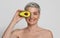 Natural Skincare. Naked Beautiful Mature Woman Covering Eve With Avocado Half