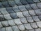 Natural slate mineral tile covered roof detail in fish scale pattern