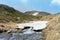 Natural snow bridge crossing a tributary river