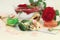 Natural soap, sea salt, buds, petals, red roses, shells and stones on the table