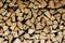 Natural stocked firewood in a pile, wooden abstract background,