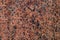 Natural stone granite background. Red granite stone. Granite untreated surface.