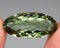 Natural stone green amethyst on a gray background