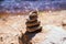 Natural stone pyramids on the river bank. Stone balance close up.Close-up abstract image of stones balanced like pyramid