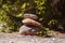 Natural stone pyramids on the river bank. Stone balance close up.Close-up abstract image of stones balanced like pyramid