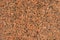 Natural stone red granite background. Bright hard red granite rock texture