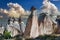 Natural stone statues against a picturesque cloudy sky in the evening in Cappadocia