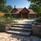 Natural stone steps and retaining wall, planter and garden border framing home entrance. Beautiful hardscape, colorful
