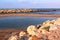 natural stony beach seaside landscape in Spain with sand spit close up photo