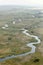 A natural stream meandering through a meadow.