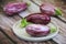 Natural striped eggplant fruits on a decorative plate