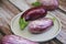 Natural striped eggplant fruits on a decorative plate