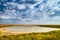 Natural summer landscape - grassy shores of salty sea firths