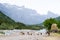 Natural summer landscape with grazing goats. Mountain valley during cloudy summer middle day