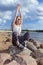 Natural Summer Portrait of Resting Relaxing Caucasian Blond Female Girl in Street Clothing Posing On Stones While Sitted On