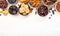 Natural sun dried fruits assortment in bowls on white background. Healthy wholesome snacks. Copy space