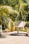 Natural sunny terrace with a string hammock hanging from a metal